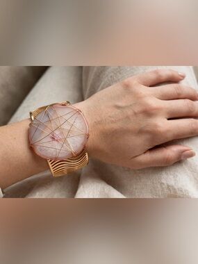 Pink stone wrapped in gold wiring bracelet